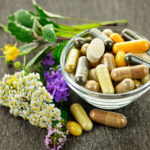 Creative photo showing natural herbs / flowers with vitamin supplements.