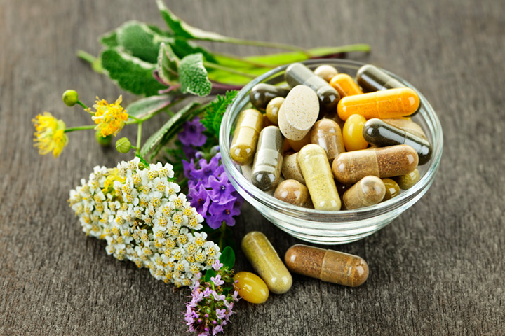 Creative photo showing natural herbs / flowers with vitamin supplements.